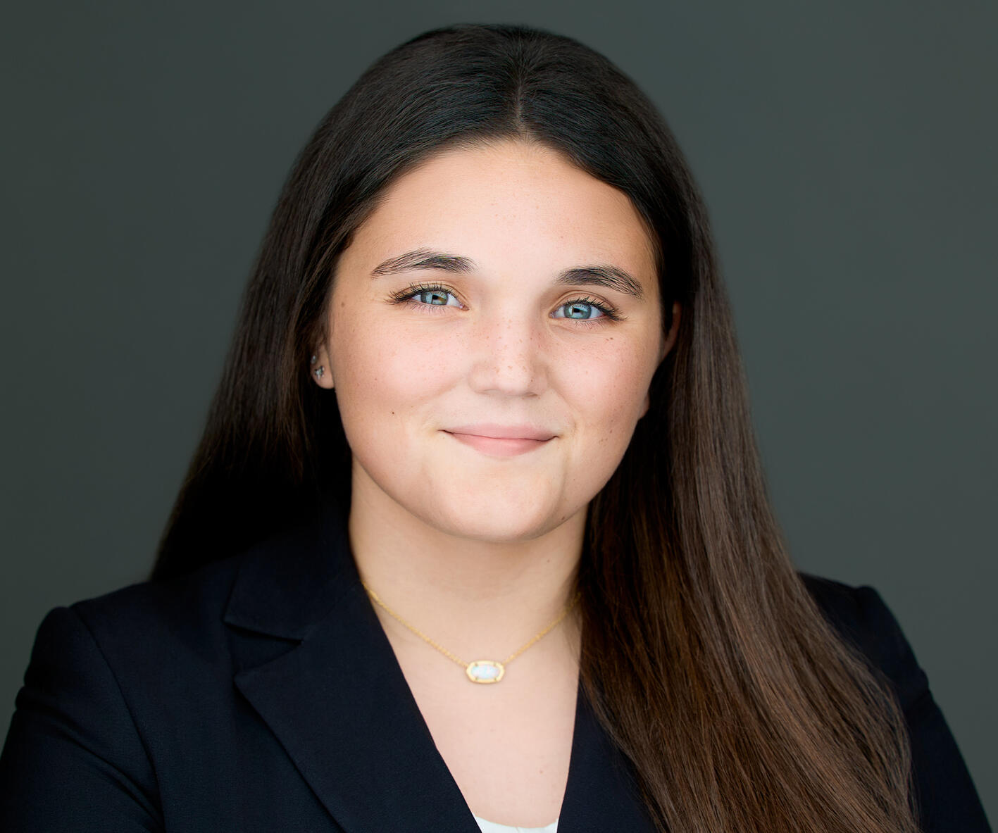 Reagan Bailey Headshot of Reagan Bailey an Agent of Kris Flores Insurance Solutions LLC, wearing a black Jacket and a gold necklace top. She has shoulder length hair of auburn to dark brown in color.