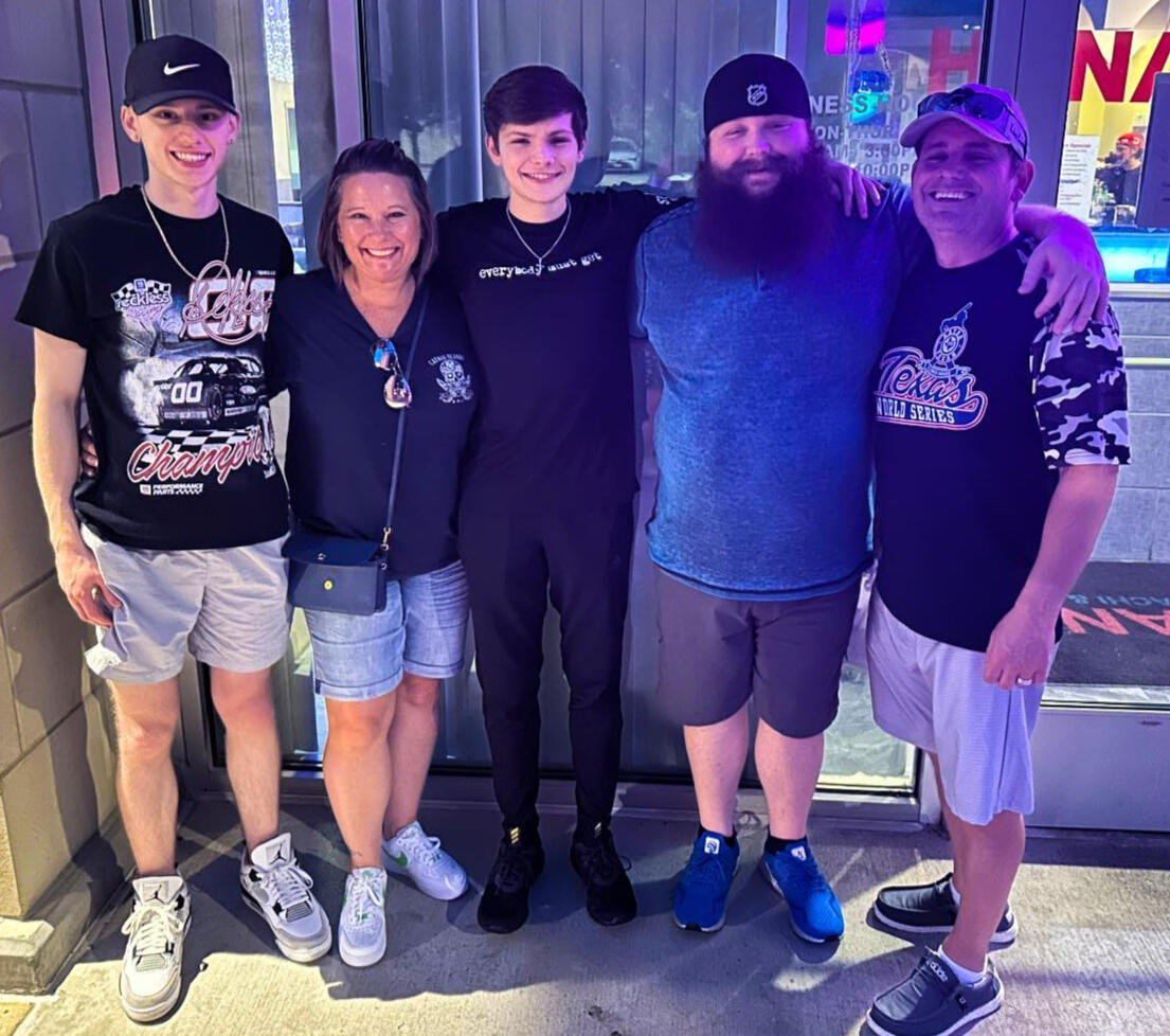 Kris Fores Family The FloresFamily, standing in a line with their arms around each other